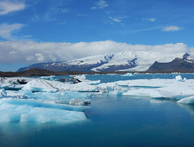 The Jokulsarlon glacier lagoon with the huge Vatnajokull ice cap behind